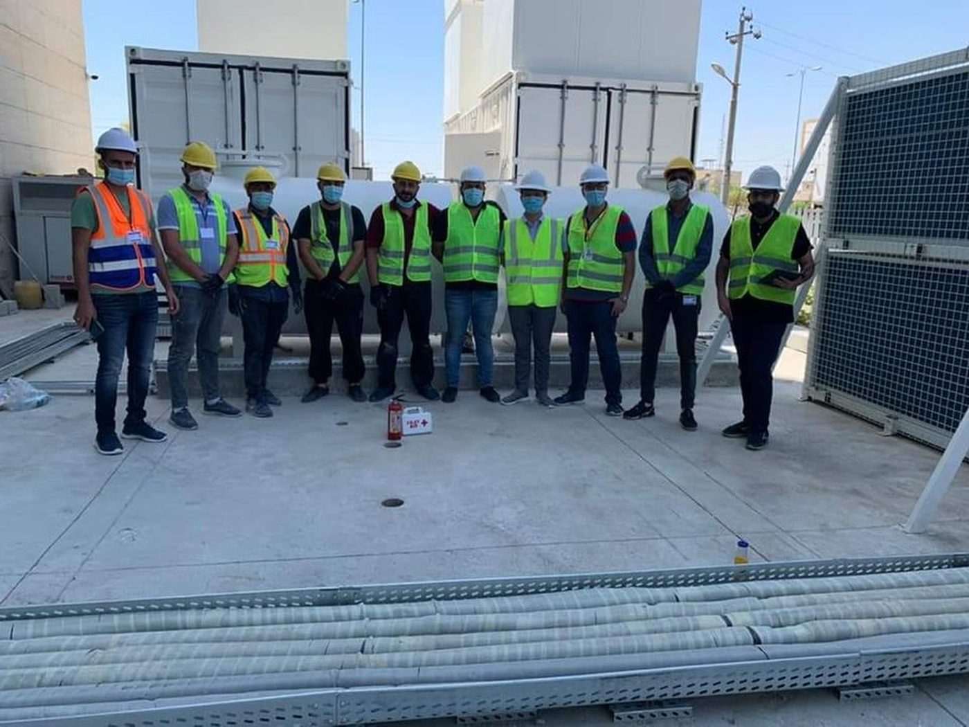Site team briefing — full PPE, safety-first execution